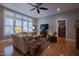 Bright living room featuring large windows, cozy seating, and stylish decor at 4331 Millcreek Cir, Pittsboro, NC 27312