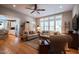 Bright living room with large windows, hardwood floors, sofas, and access to the kitchen at 4331 Millcreek Cir, Pittsboro, NC 27312