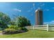 Classic silo and village center sign with lush greenery and clear blue sky at 4331 Millcreek Cir, Pittsboro, NC 27312