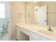 Bright bathroom featuring a white vanity, large mirror, and a glimpse of a shower at 4501 Forest Dr, Holly Springs, NC 27540