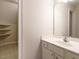 Bathroom featuring a white vanity and mirror, as well as a glimpse of shelving at 4501 Forest Dr, Holly Springs, NC 27540