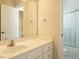 Bathroom featuring a white vanity, large mirror, and view of a shower at 4501 Forest Dr, Holly Springs, NC 27540