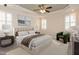 Beautiful staged bedroom with neutral colors, plantation shutters, and ceiling fan at 4501 Forest Dr, Holly Springs, NC 27540