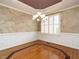 Dining room featuring a unique ceiling, decorative chandelier, wainscoting, and hardwood floors with decorative inlay at 4501 Forest Dr, Holly Springs, NC 27540