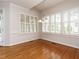 Dining room with hardwood floors, large windows, and plantation shutters at 4501 Forest Dr, Holly Springs, NC 27540