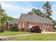 Brick home featuring a large driveway and well-manicured lawn and landscaping at 4501 Forest Dr, Holly Springs, NC 27540