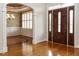 Elegant foyer with hardwood floors, an archway, and a view into the dining area with detailed wainscoting at 4501 Forest Dr, Holly Springs, NC 27540
