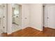 Hallway with hardwood floors leading to a laundry room at 4501 Forest Dr, Holly Springs, NC 27540