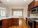 Kitchen with stainless steel appliances, wood floors, eat in area, and plenty of natural light at 4501 Forest Dr, Holly Springs, NC 27540