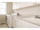 Laundry room with washer, dryer, utility sink, and white cabinets at 4501 Forest Dr, Holly Springs, NC 27540