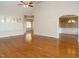 Bright living room boasting hardwood floors, archways, plantation shutters, and great natural light at 4501 Forest Dr, Holly Springs, NC 27540
