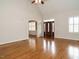 Open-concept living room with hardwood floors, a fireplace, built-ins, and natural light at 4501 Forest Dr, Holly Springs, NC 27540