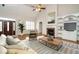 Staged living room with a cozy seating area, fireplace, built-ins, and plenty of natural light at 4501 Forest Dr, Holly Springs, NC 27540