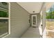 Back porch with view to the house's grey siding, windows and door at 479 Kotata Ave, Bunnlevel, NC 28323