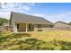 Backyard featuring a green lawn, house with windows and siding at 479 Kotata Ave, Bunnlevel, NC 28323