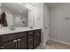 Bathroom showcasing dual sinks, dark cabinetry, ample lighting and tile flooring at 479 Kotata Ave, Bunnlevel, NC 28323