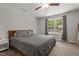 Bedroom features a queen sized bed, plush carpeting and large windows with backyard views at 479 Kotata Ave, Bunnlevel, NC 28323