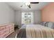 Neutral bedroom with ceiling fan and a large window providing natural light at 479 Kotata Ave, Bunnlevel, NC 28323
