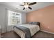 Comfortable bedroom with neutral walls, ceiling fan and a sun-filled window view at 479 Kotata Ave, Bunnlevel, NC 28323