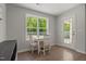 Bright dining area with backyard views, features a small table and chairs, and wood-look flooring at 479 Kotata Ave, Bunnlevel, NC 28323