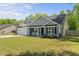 Charming home featuring a manicured lawn, rocking-chair front porch and attached two-car garage at 479 Kotata Ave, Bunnlevel, NC 28323