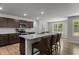 A modern kitchen with granite countertops, stainless steel appliances and dark brown cabinetry at 479 Kotata Ave, Bunnlevel, NC 28323