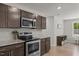 Well-equipped kitchen with stainless steel appliances, granite countertops, and sleek dark cabinetry at 479 Kotata Ave, Bunnlevel, NC 28323