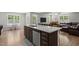 Modern kitchen featuring a granite island, stainless steel appliances, and an open layout to the living area at 479 Kotata Ave, Bunnlevel, NC 28323