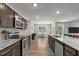 Stylish kitchen with granite countertops, stainless steel appliances, and dark cabinets, open to the dining area at 479 Kotata Ave, Bunnlevel, NC 28323