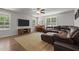 Spacious living area with large TV, comfortable sectional, and piano, creating a cozy entertainment space at 479 Kotata Ave, Bunnlevel, NC 28323