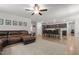 Open concept living area with leather sectional, kitchen island with bar stools, and natural light at 479 Kotata Ave, Bunnlevel, NC 28323