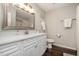 Bright bathroom featuring a white vanity, chrome fixtures, and a large framed mirror at 48 Fashion Pl, Durham, NC 27705