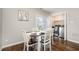 Bright dining area features a view of laundry room, modern appliances, and hardwood floors at 48 Fashion Pl, Durham, NC 27705