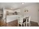 Bright dining area connected to kitchen with stainless steel appliances and hardwood floors at 48 Fashion Pl, Durham, NC 27705