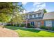 Charming townhome with a brick facade, blue shutters, and a well-maintained lawn at 48 Fashion Pl, Durham, NC 27705