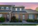 Beautiful townhome featuring brick facade and blue shutters under a dusk sky at 48 Fashion Pl, Durham, NC 27705