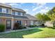 Brick townhomes feature blue shutters, neutral siding and landscaping creating a sense of community at 48 Fashion Pl, Durham, NC 27705
