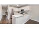Modern kitchen with white cabinets, stainless steel appliances, and a peninsula for easy entertaining at 48 Fashion Pl, Durham, NC 27705