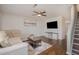 Inviting living room featuring a comfortable sectional sofa, stylish decor, and hardwood flooring at 48 Fashion Pl, Durham, NC 27705