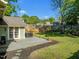 Large backyard features a wooden deck, green grass, and landscaping at 501 Mallard Ave, Durham, NC 27701