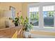 A cozy bedroom with a wood dresser, decor, bright windows, and natural light flooding the space at 501 Mallard Ave, Durham, NC 27701