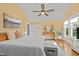 Light-filled bedroom featuring a large bed, neutral colors, natural wood floors, and bright windows with natural light at 501 Mallard Ave, Durham, NC 27701