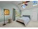 Comfortable bedroom with light-colored walls, ceiling fan, and large windows providing bright, natural lighting at 501 Mallard Ave, Durham, NC 27701