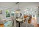 Bright dining area with a modern chandelier, flowing into a kitchen with a butcher block island at 501 Mallard Ave, Durham, NC 27701