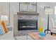 Close up of a modern fireplace with stone accents and a stylish wooden mantel in a well-lit living space at 501 Mallard Ave, Durham, NC 27701