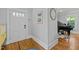 Bright foyer with hardwood floors, showcasing a view into a living space with a grand piano at 501 Mallard Ave, Durham, NC 27701