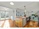 Open-concept kitchen featuring a large island with sink, and view of the living area at 501 Mallard Ave, Durham, NC 27701