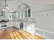 Bright kitchen with white cabinetry, stainless appliances, and sun-drenched hardwood floors at 501 Mallard Ave, Durham, NC 27701