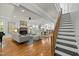 Open concept living room with a fireplace, modern furnishings, and a view of the staircase at 501 Mallard Ave, Durham, NC 27701