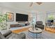 Spacious living room with a wall-mounted TV, modern shelving, and views to an office at 501 Mallard Ave, Durham, NC 27701